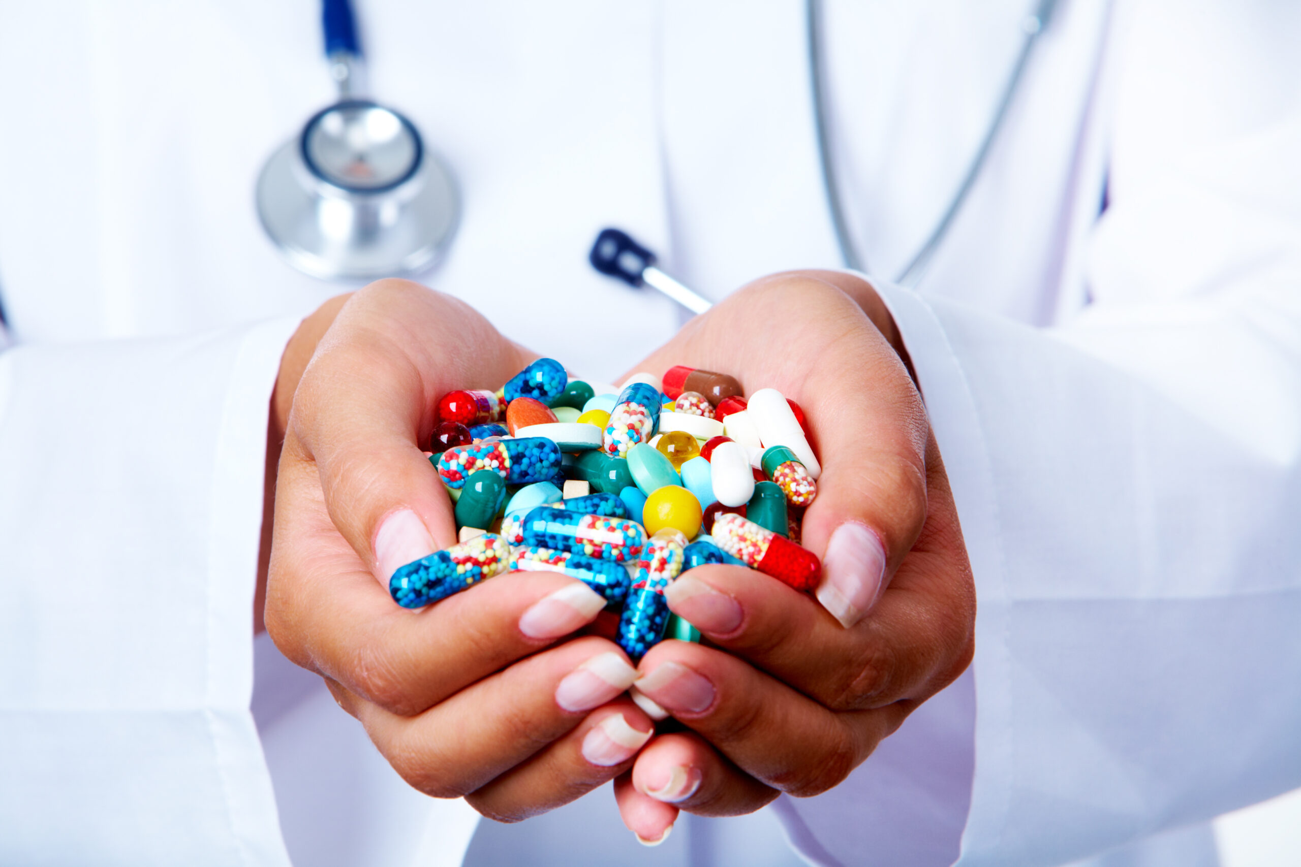 Physician with handful of vitamins